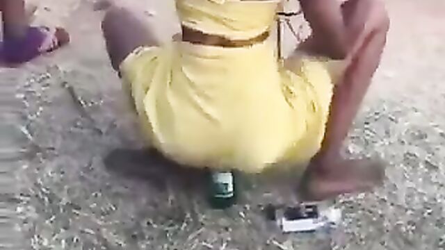 Girl Goes Wild With A Bottle In Her Pussy In Public At An African Party - 1 image