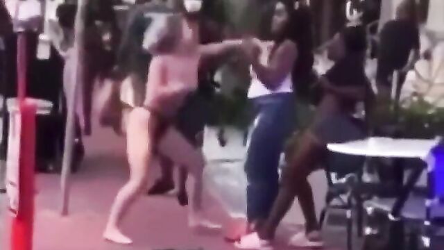 Boobs out, as white chick with naked breasts beats up black side chicks in public - 1 image