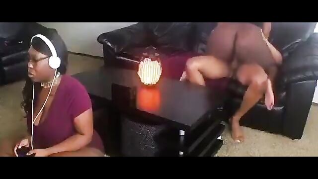 Sister playing video game while her brother is chopping - 1 image