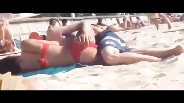 Couple having discreet sex on the beach in public - 3 image