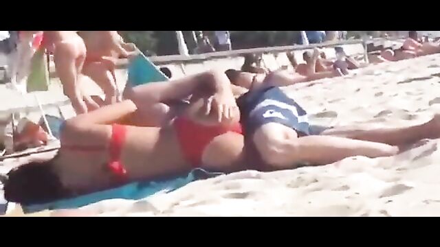 Couple having discreet sex on the beach in public - 4 image