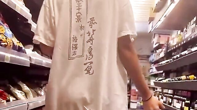 Chick strips naked in a public store, showing ass and boobs - 1 image