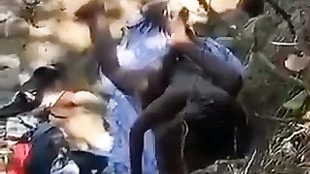 Naked ebony couple caught having sex in the bush in public without giving a damn