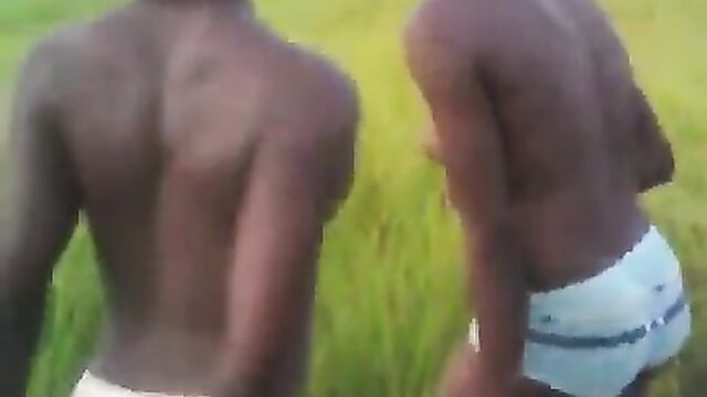 2 African girls with naked breasts and panties dancing for their sugar daddy in public - 1 image