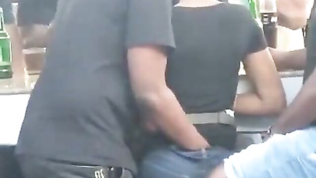 Guy fingering and squeezing his girlfriend’s buttocks at a bar