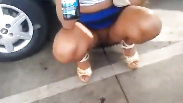 Drunk woman caught peeing in public - 1 image