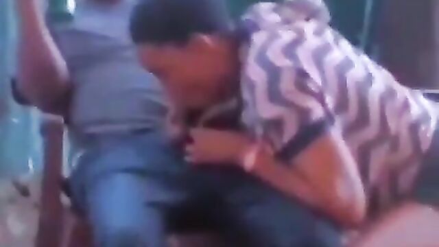 African girl giving sugar daddy blow job in public in a restaurant - 1 image