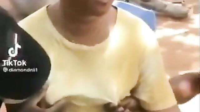 2 guys playing with Ashawo’s breasts and nipples in public - 1 image