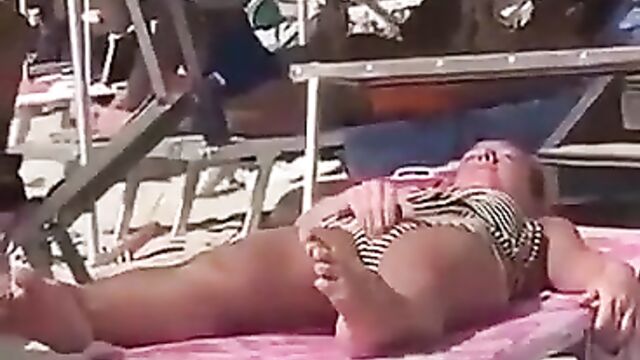 Chick caught fingering herself on the beach in public