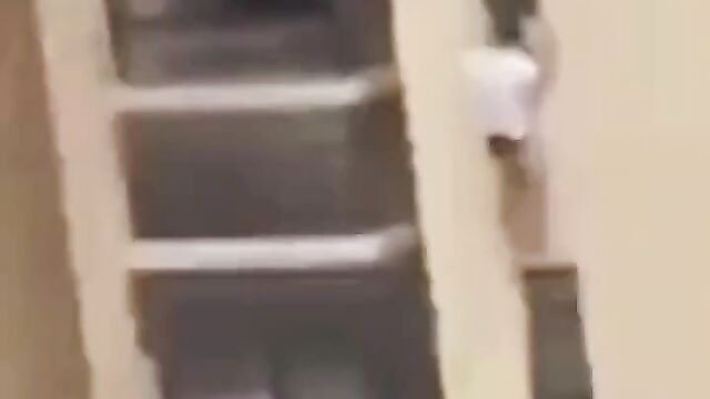 Side guy hides outside apartment window of high rise building, after his married girlfriend’s husband returned home too early! - 1 image