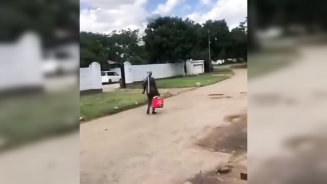 Naked mad woman walking away from agents - 2 image