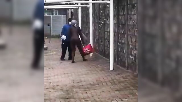 Naked mad woman walking away from agents