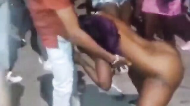 Guy receiving blow job from a naked stripper in public at a Jamaican club party