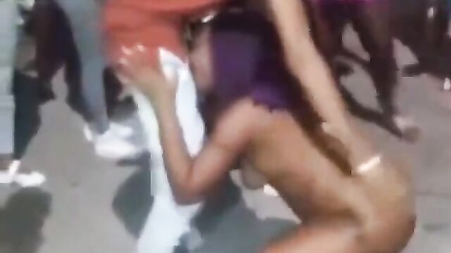 Guy receiving blow job from a naked stripper in public at a Jamaican club party - 4 image