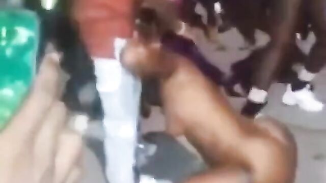 Guy receiving blow job from a naked stripper in public at a Jamaican club party - 5 image
