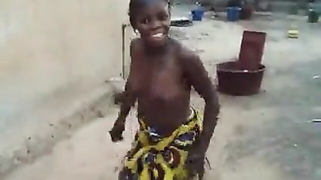 African girl caught dancing with naked breasts in public - 1 image