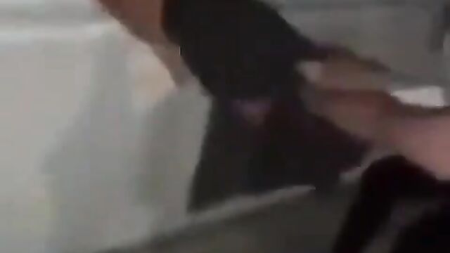 Boobs out as girl’s shirt comes off while her opponent pulls her by the hair over a window while fighting