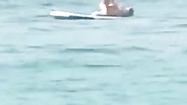 Naked couple caught having sex on floater board in the ocean - 3 image