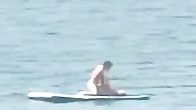 Naked couple caught having sex on floater board in the ocean - 4 image