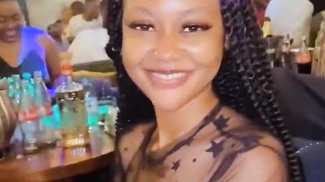 Nigerian girl showing her naked breasts at a party in public while wearing a transparent dress - 1 image