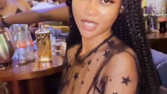 Nigerian girl showing her naked breasts at a party in public while wearing a transparent dress