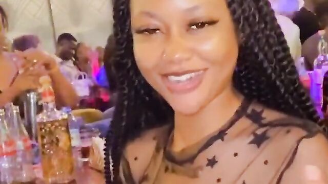 Nigerian girl showing her naked breasts at a party in public while wearing a transparent dress - 3 image