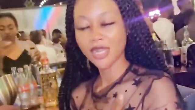 Nigerian girl showing her naked breasts at a party in public while wearing a transparent dress - 4 image