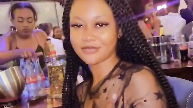 Nigerian girl showing her naked breasts at a party in public while wearing a transparent dress - 5 image