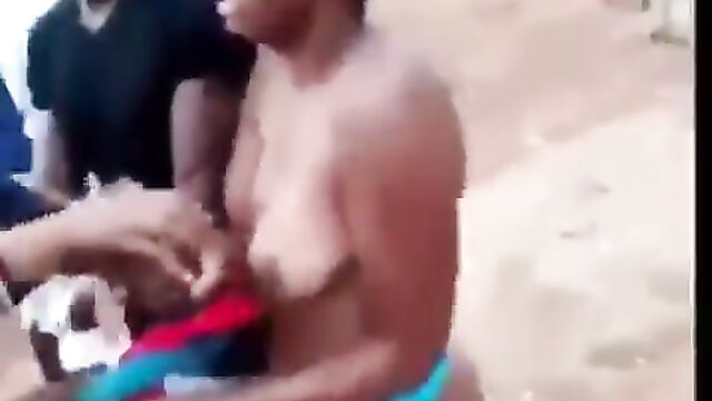 Chick stripped NAKED and beaten for allegedly cheating with a married man - 1 image