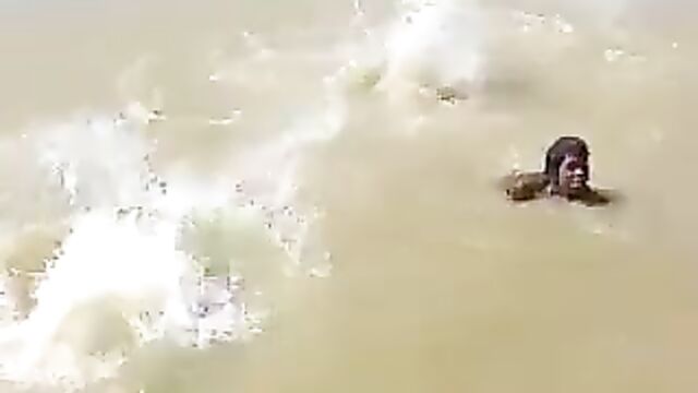 3 African ladies showing their breasts in a river