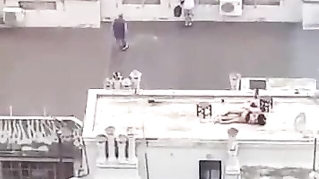 Naked couple caught bonking on a roof-deck in public