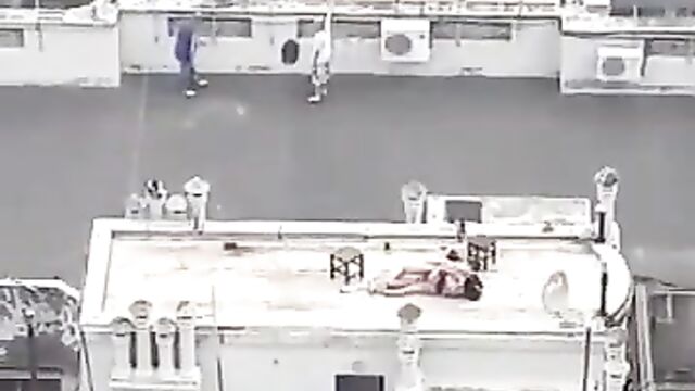 Naked couple caught bonking on a roof-deck in public - 3 image