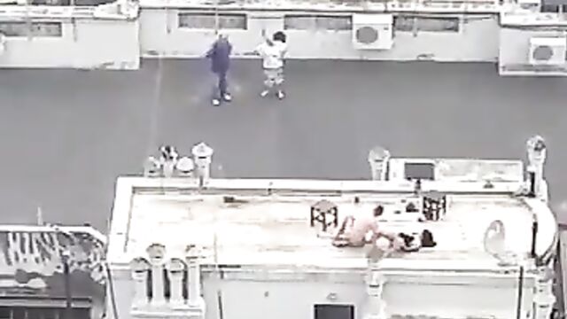 Naked couple caught bonking on a roof-deck in public - 4 image