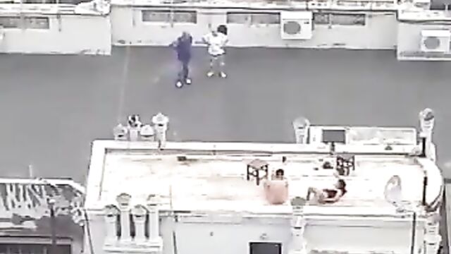 Naked couple caught bonking on a roof-deck in public - 5 image