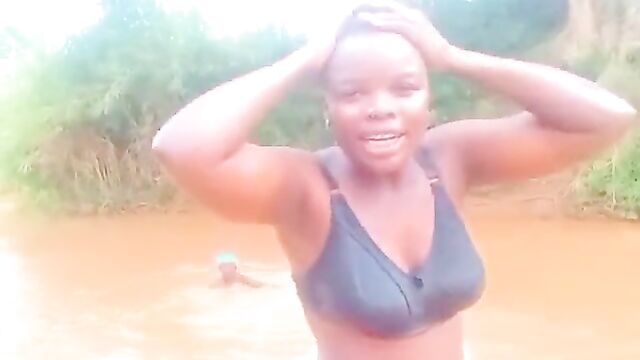African girls showing their breasts in a river - 1 image