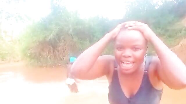African girls showing their breasts in a river