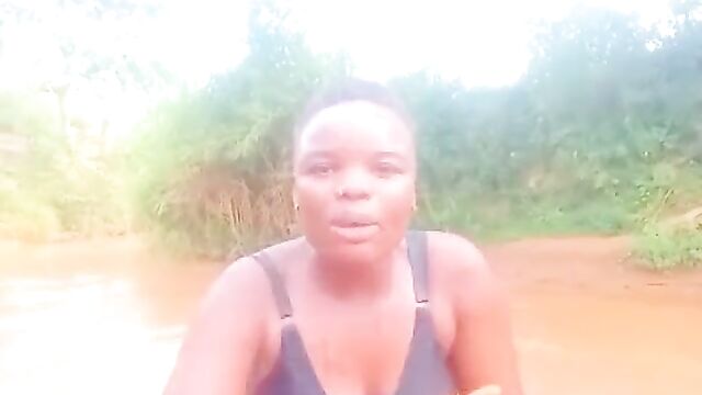 African girls showing their breasts in a river - 3 image