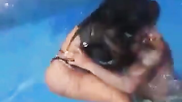 Horny couple having sex in a pool in public - 5 image