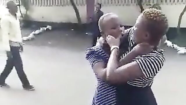 2 African girls fighting dirty, showing ass and panties in public over a man - 1 image