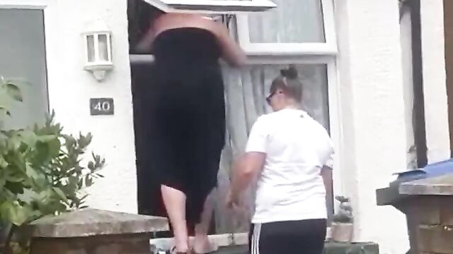 Boobs Out In Public As Woman Falls Upside Down While Trying To Enter An Apartment Through The Window - 1 image