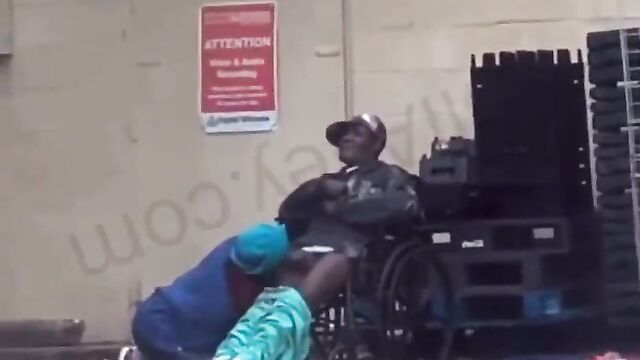 Disabled Guy Receiving Blow Job On A Wheelchair In Public - 1 image