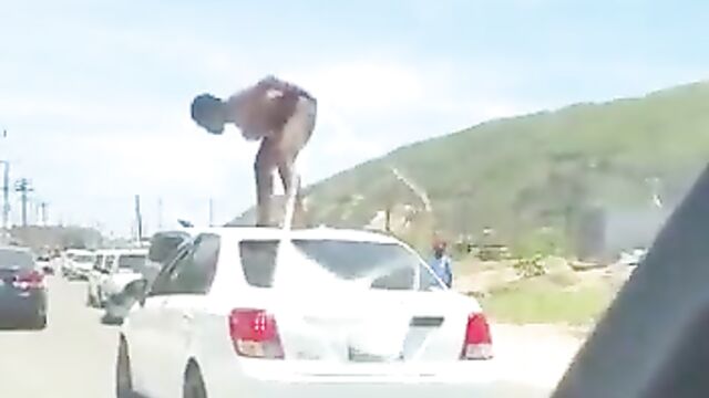 Naked Mad African Woman With Fine Boobs And Ass Standing On A Car In Public And Obstructing Traffic - 1 image
