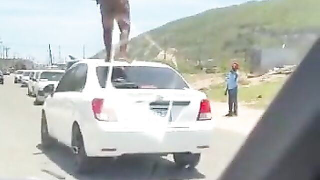 Naked Mad African Woman With Fine Boobs And Ass Standing On A Car In Public And Obstructing Traffic - 3 image
