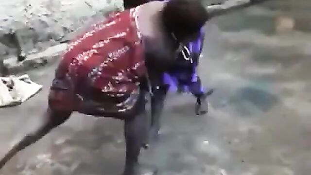 Boobs and ass exposed as African housewife beats and strips her neighbor naked in public for having sex with her husband - 1 image