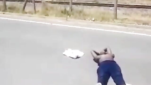 Half naked woman with big breasts protesting in public on the road in South Africa