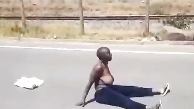 Half naked woman with big breasts protesting in public on the road in South Africa - 3 image