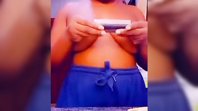 Ebony babe with naked breasts caught rolling weed on camera - 3 image