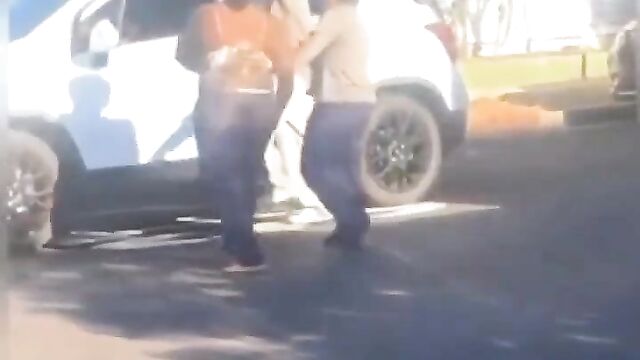 Big breasts pop out in public as couple fight dirty on the street