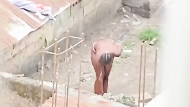 Naked African queen caught bathing outside in public