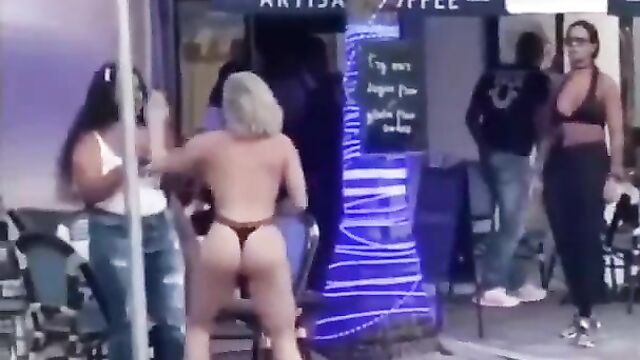 Ass and boobs out as white chick fights black girl in public - 1 image